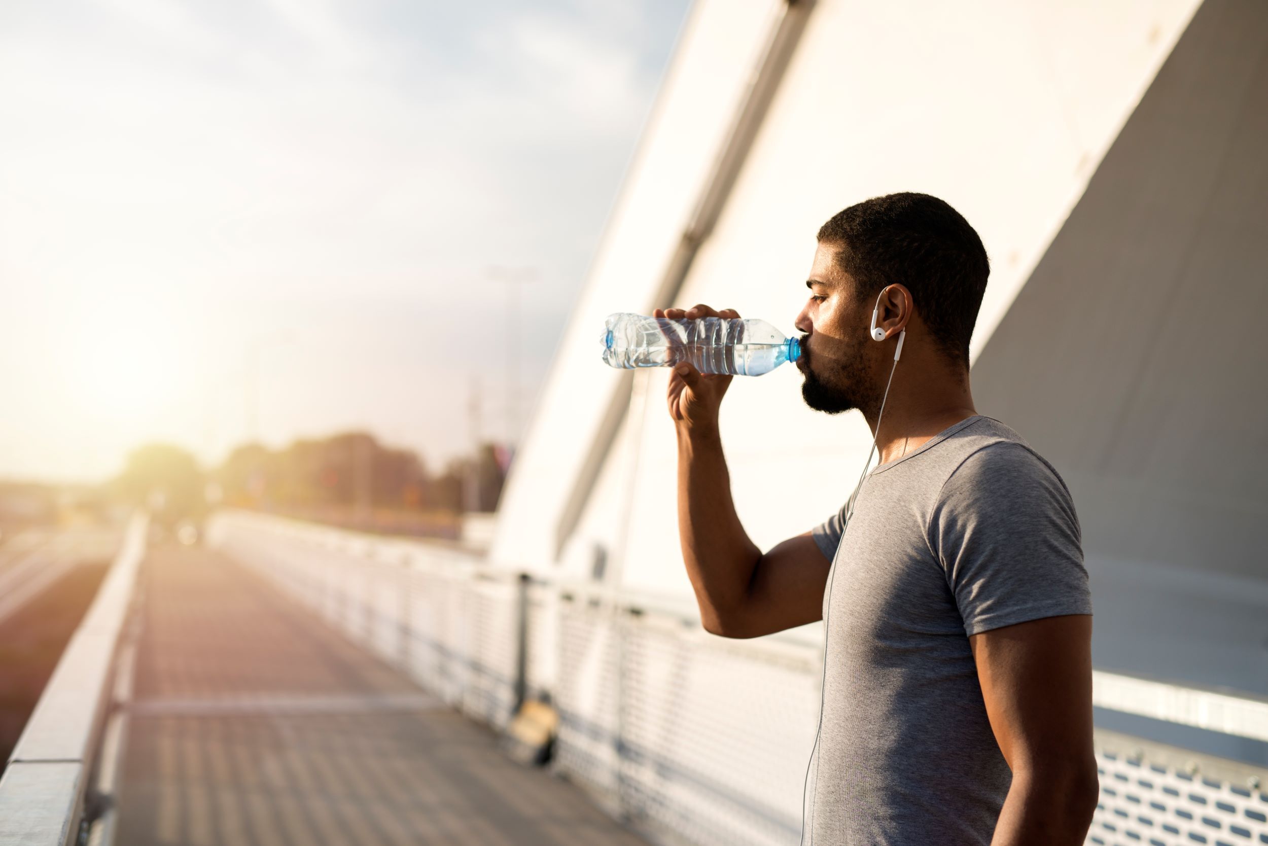 attractive-athlete-holding-bottle-water-drinking-before-training.jpg