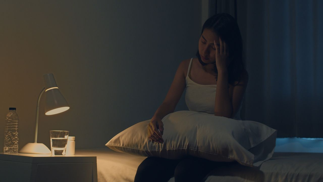 beautiful-asian-young-woman-sitting-bed-take-sleeping-pill-night-medicine-bedroom-unhealthy-sick-indian-female-suffers-from-insomnia-headache-depressed-girl-holds-antidepressant-meds.jpg