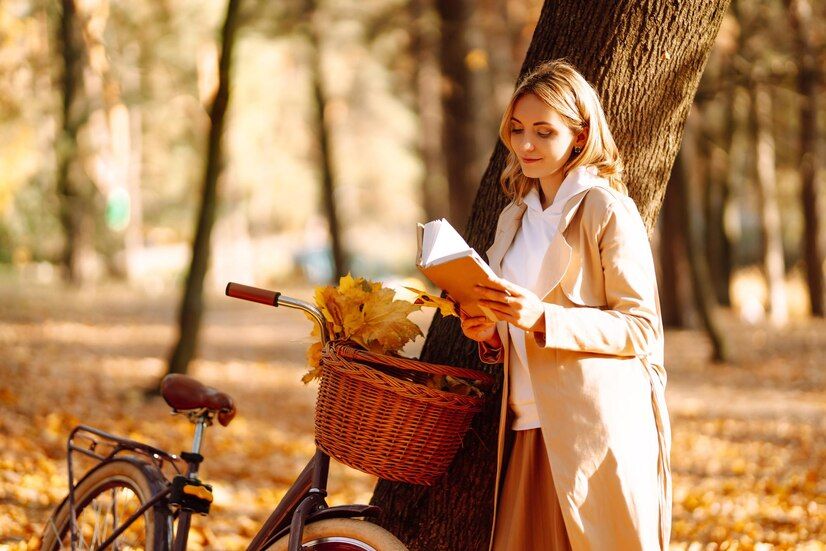 beautiful-young-woman-sitting-fallen-autumn-leaves-park-reading-book-relaxation_217236-19214.jpg