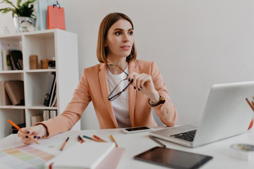 browneyed-business-lady-bright-jacket-poses-sitting-desk-white-office_197531-25723.jpg