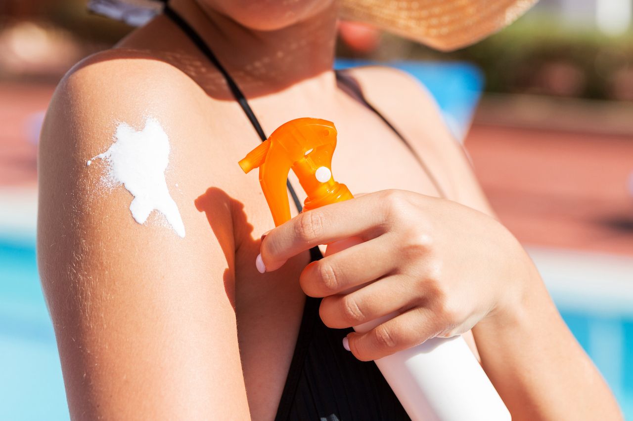 caucasian-woman-putting-solar-cream-her-shoulder-by-pool-sunshine-summer-day-sun-protection-factor-vacation-concept.jpg