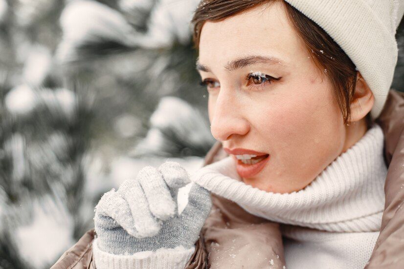 close-up-portrait-woman-brown-jacket-snowy-park_1157-45953.jpeg