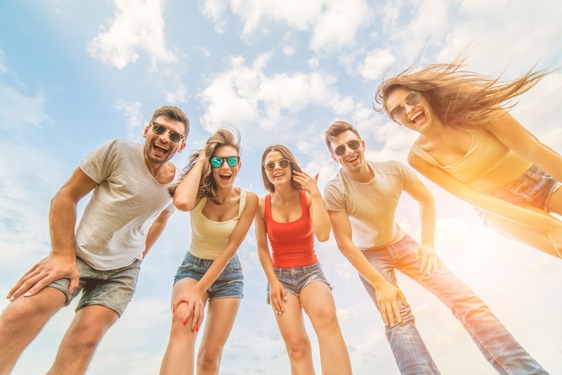 five-happy-people-look-camera-blue-clouds-background.jpg