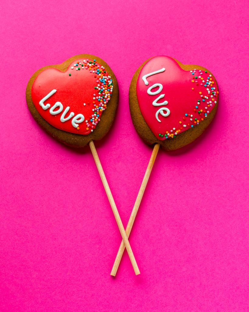 flat-lay-heart-shaped-cookies-stick-pink-background.jpg