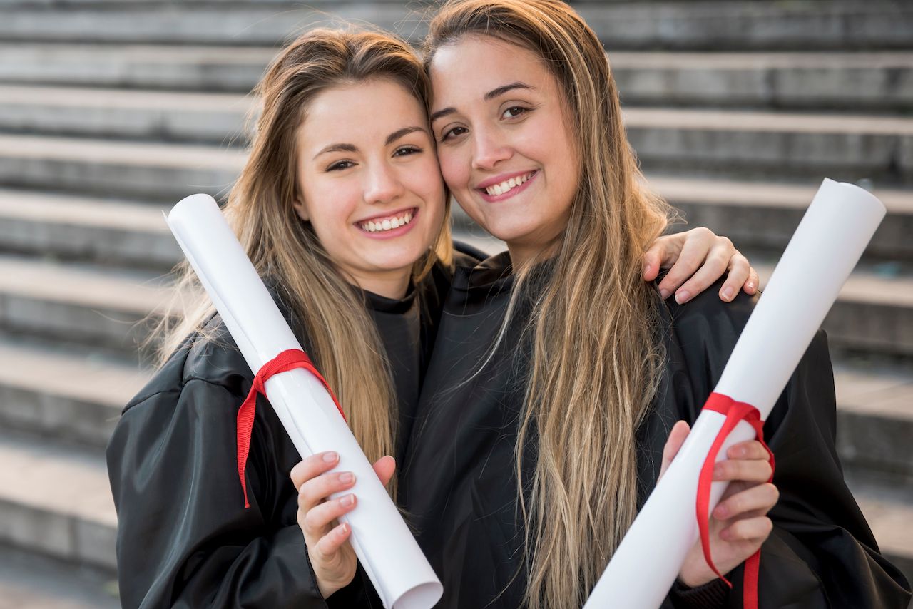 front-view-girls-holding-their-college-certificates.jpg