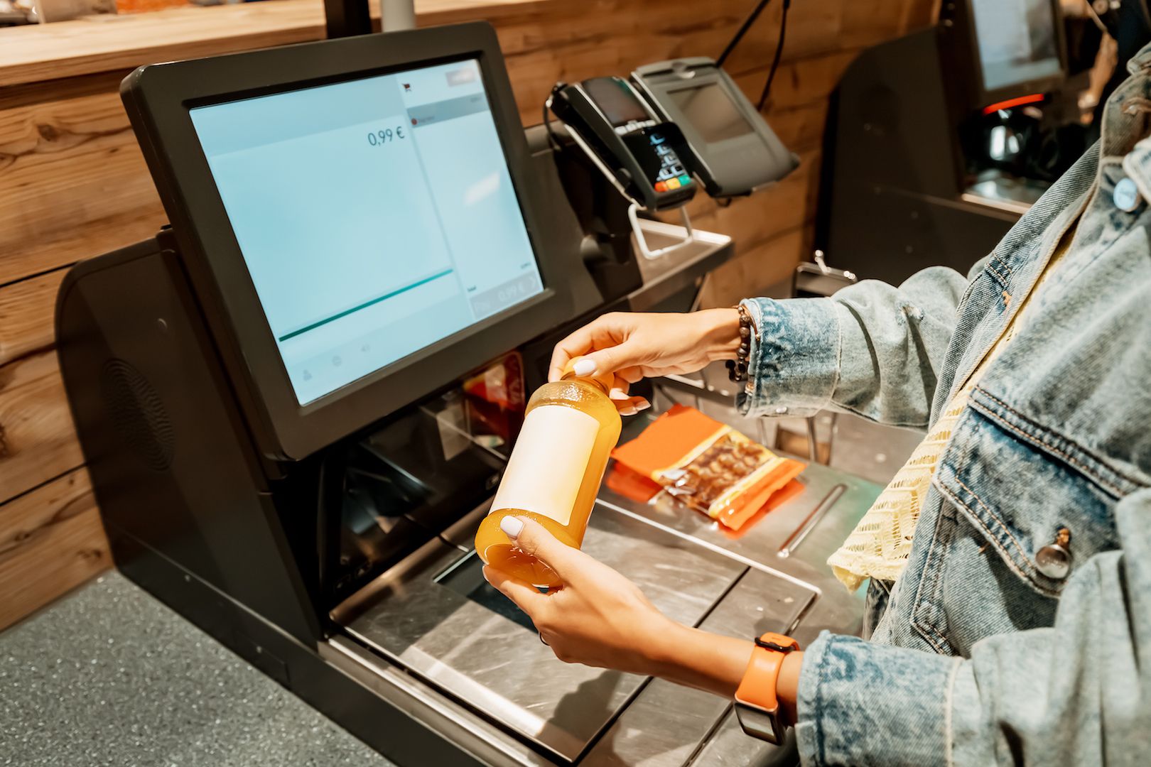 girl-customer-scanns-pays-bottle-juice-from-supermarket-automated-selfservice-checkout-terminal.jpg