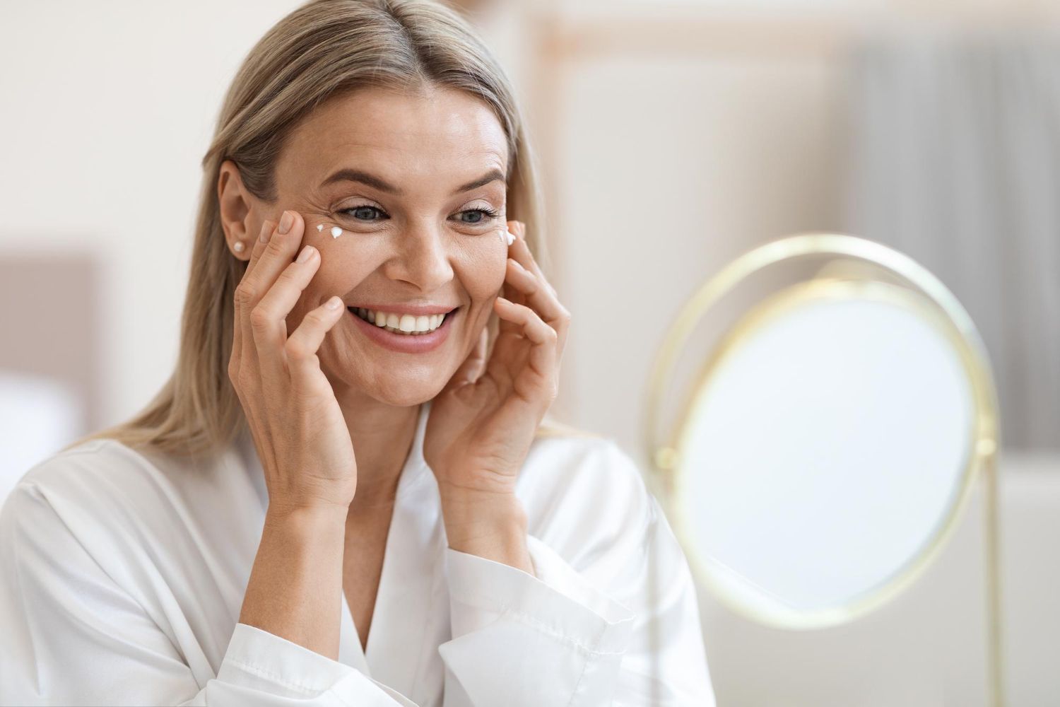 happy-beautiful-adult-lady-using-moisturizing-eye-cream.jpg