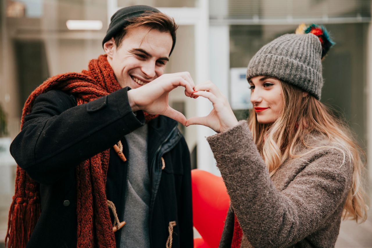 happy-couple-making-heart-gesture.jpg