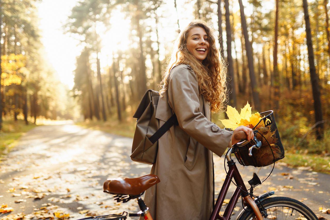 happy-woman-with-curly-hair-rides-bicycle-sunny-autumn-park-outdoor-lifestyle-nature-concept.jpg