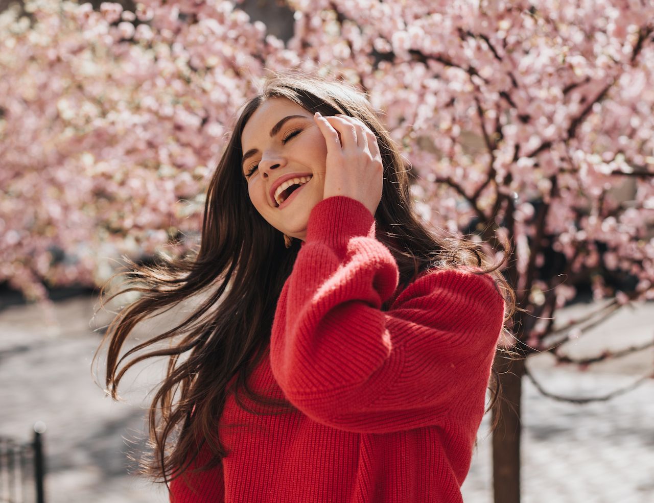 lady-red-sweater-laughs-plays-with-hair-against-background-sakuras-happy-woman-cashemere-cardigan-jeans-posing-outside.jpg