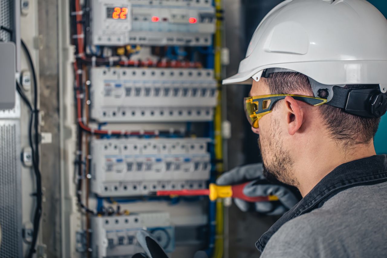 man-electrical-technician-working-switchboard-with-fuses.jpg