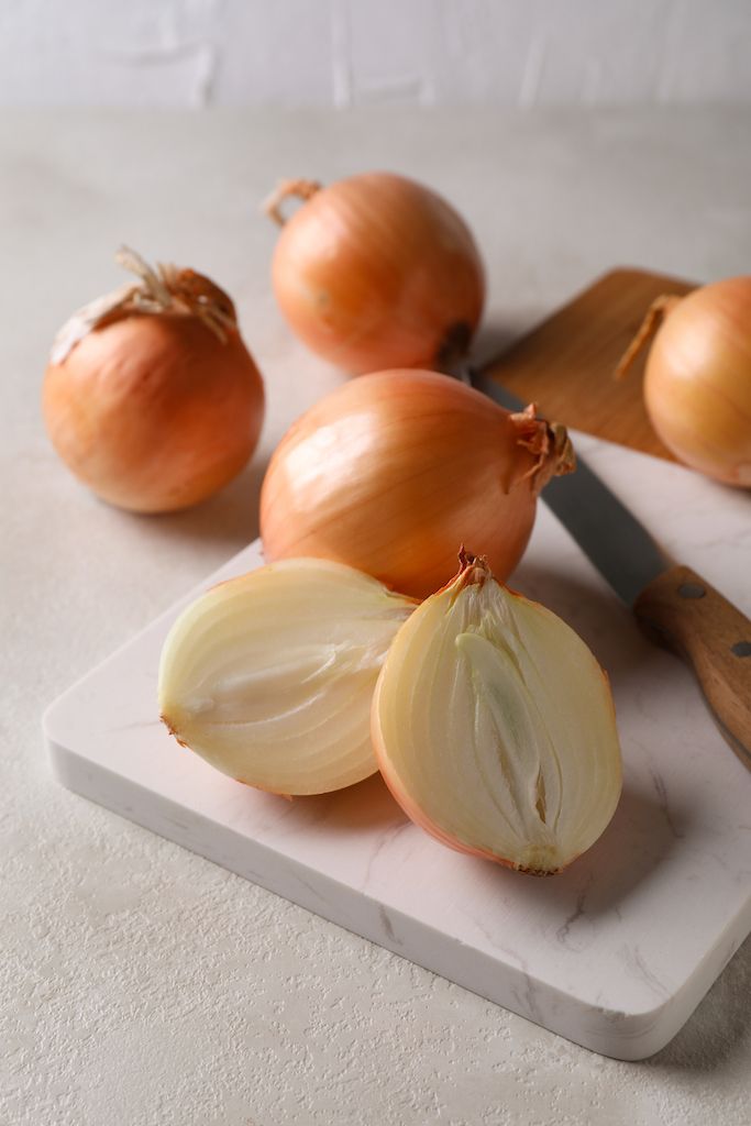 marble-wooden-board-with-fresh-onion-white-textured-table.jpg