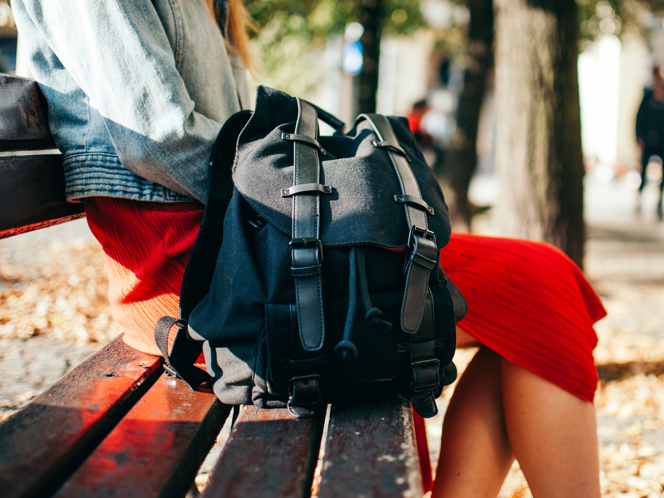 midsection-woman-with-backpack-sitting-bench-park (1).jpg