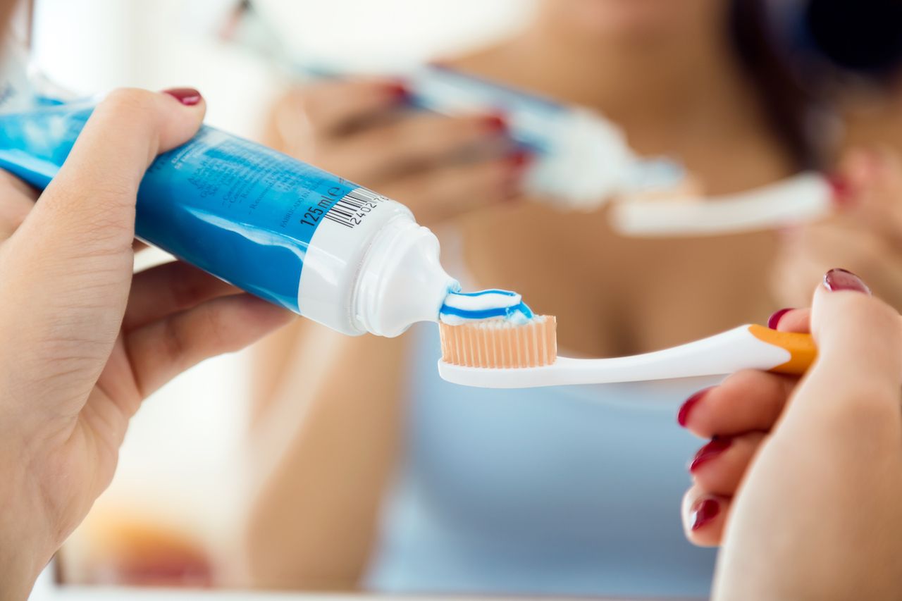 pretty-young-woman-brushing-her-teeth-bathroom.jpg