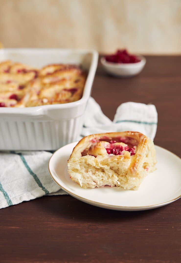 selective-focus-shot-delicious-currants-snail-pastries-plate-wooden-table_181624-44505.jpg