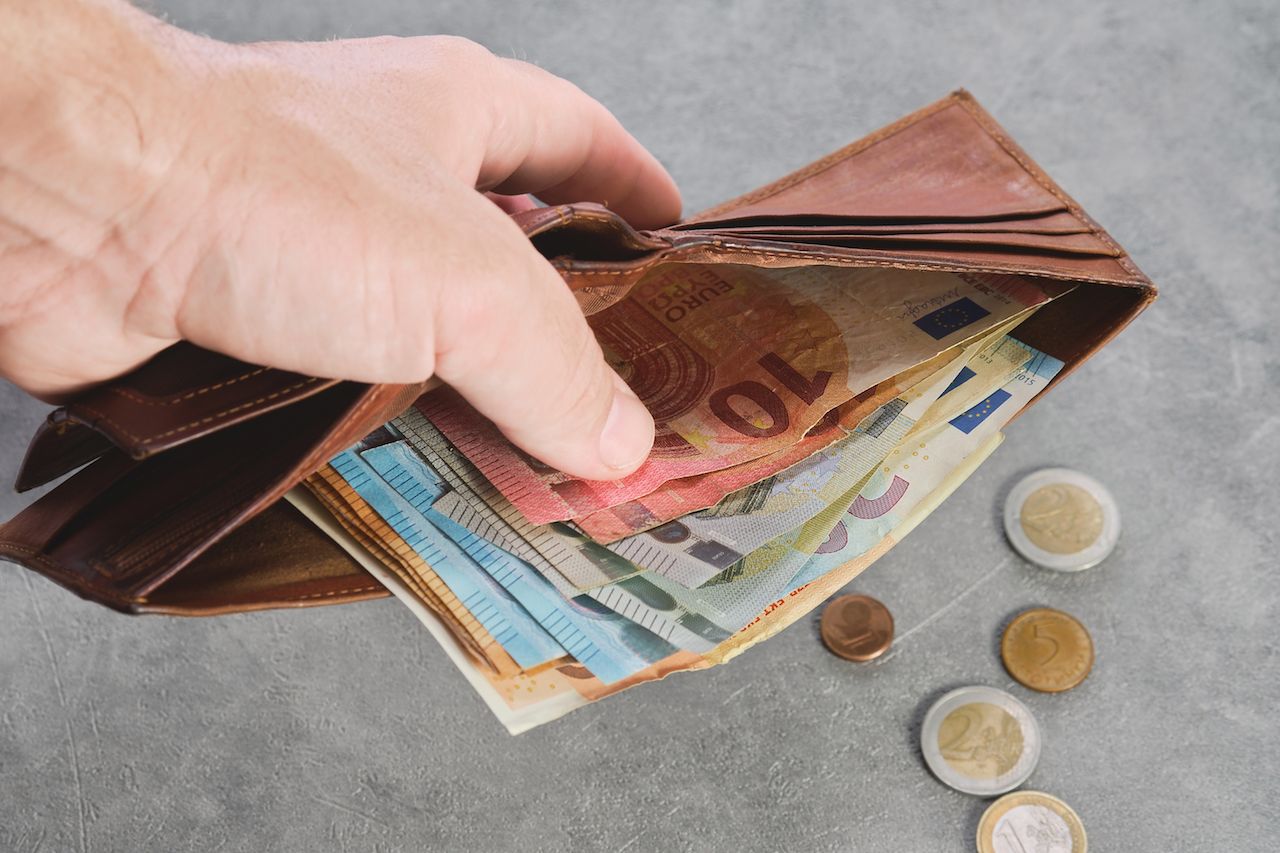 senior-man-holds-wallet-with-euro-banknotes-his-hand-euro-banknotes-wallet-wallet-with-money-man-s-hand-background-idea-paying-taxes-buying-paying-services.jpg