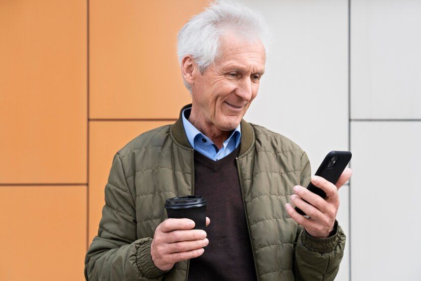 smiley-older-man-city-using-smartphone-while-having-coffee_23-2148991085.jpg