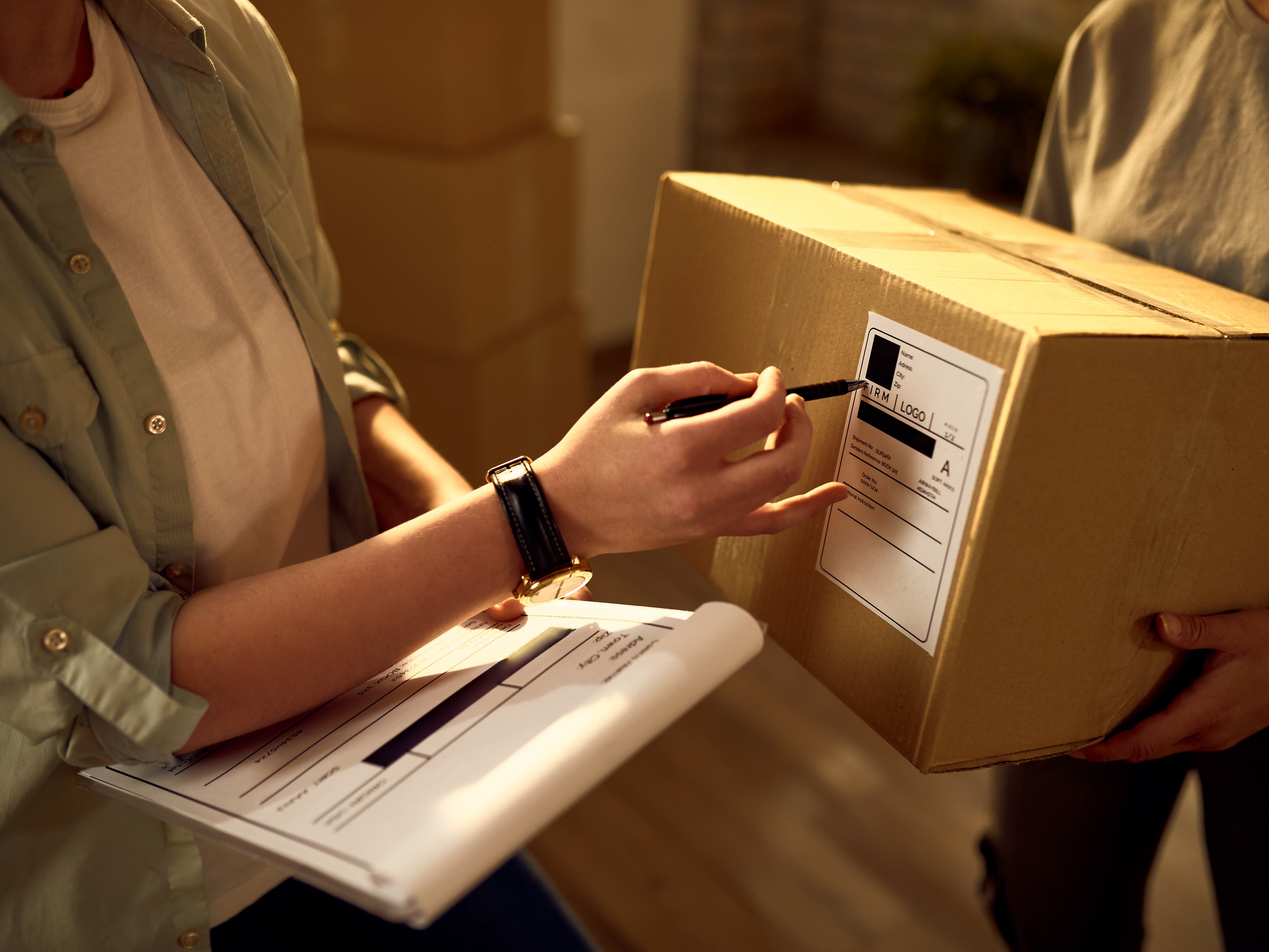 two-delivery-women-cooperating-while-checking-data-packages-office (1).jpg