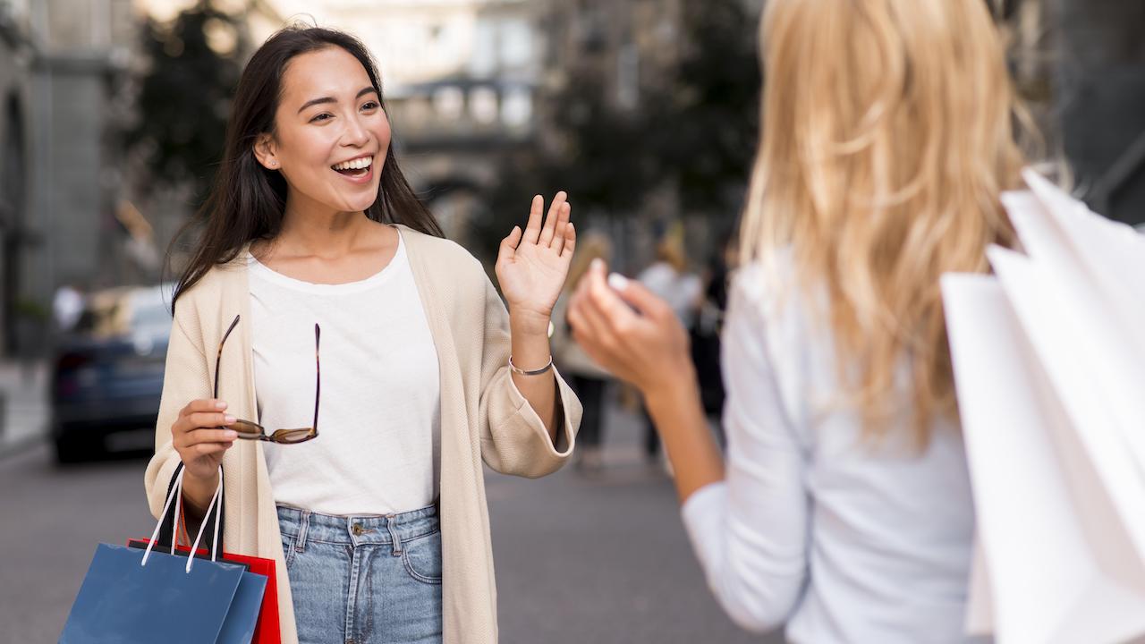 two-friends-meet-each-other-after-session-sale-shopping.jpg