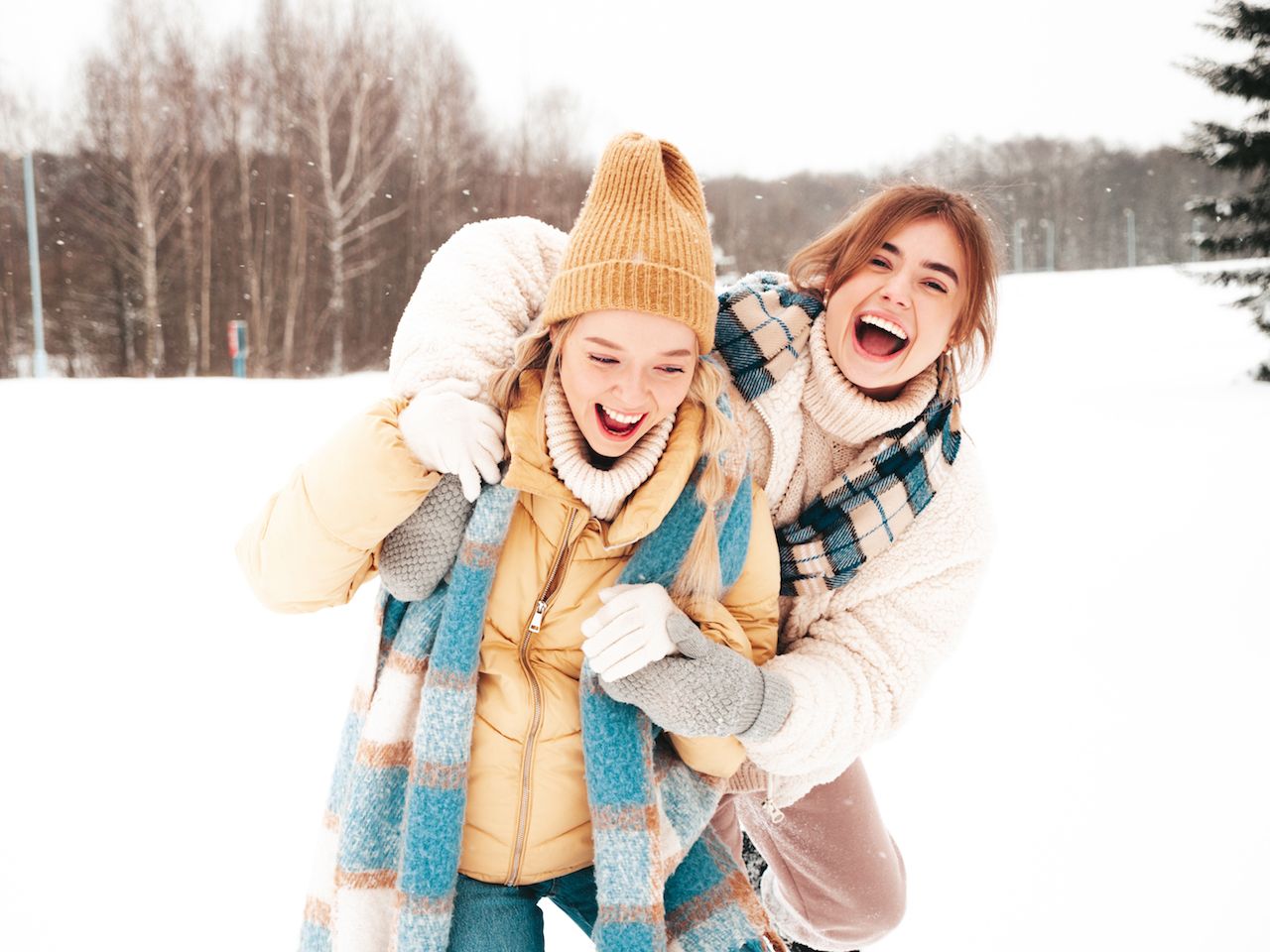two-young-beautiful-smiling-hipster-female-trendy-warm-clothes-scarfs-carefree-women-posing-street-park-positive-pure-models-having-fun-snow-enjoying-winter-moments-xmas-concept-2.jpg
