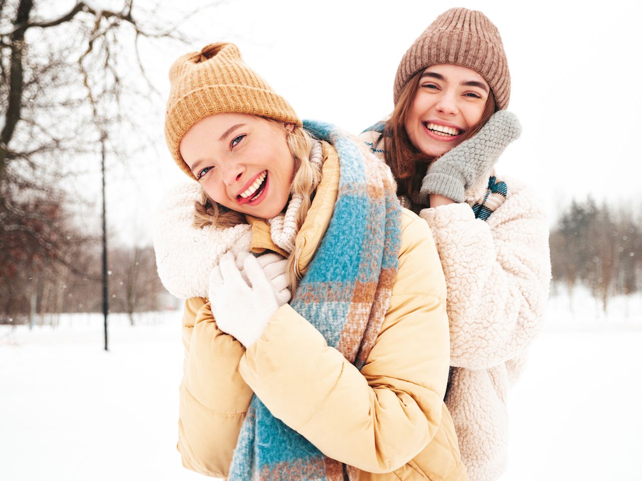 two-young-beautiful-smiling-hipster-female-trendy-warm-clothes-scarfs-carefree-women-posing-street-park-positive-pure-models-having-fun-snow-enjoying-winter-moments-xmas-concept-3.jpg
