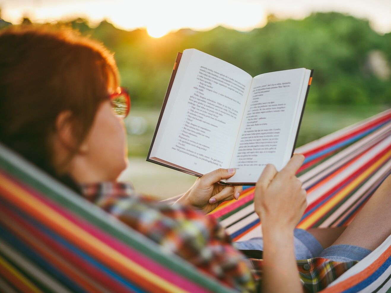 woman-reading-book-while-resting-hammock-sunset (1).jpg