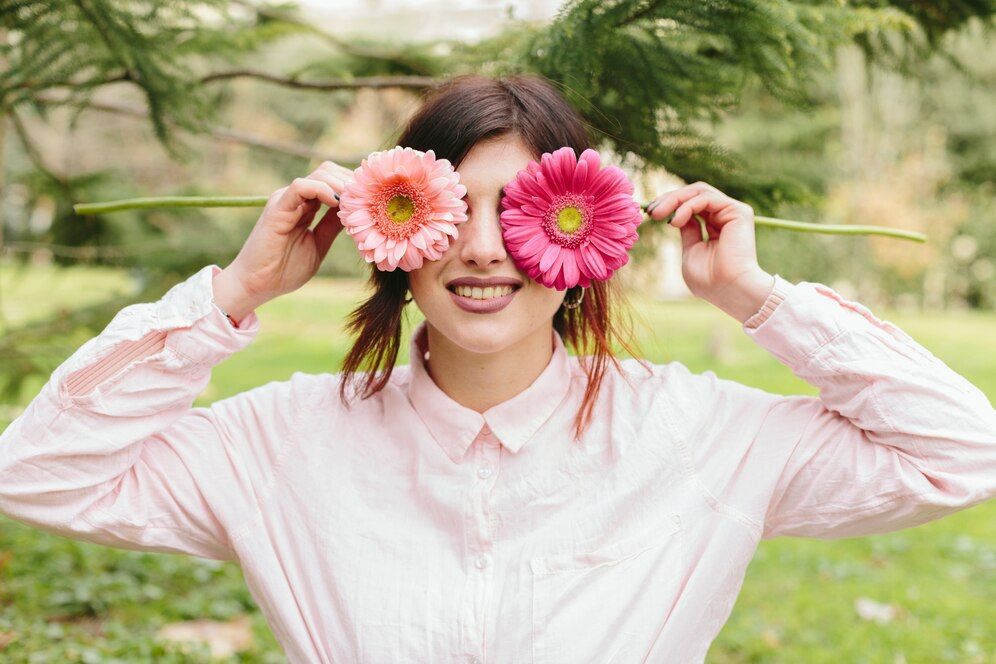 young-woman-covering-eyes-flowers-smiling_23-2148072144.jpg