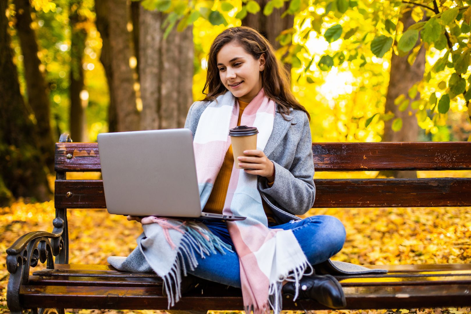 young-woman-is-using-laptop-park-autumn-day.jpg