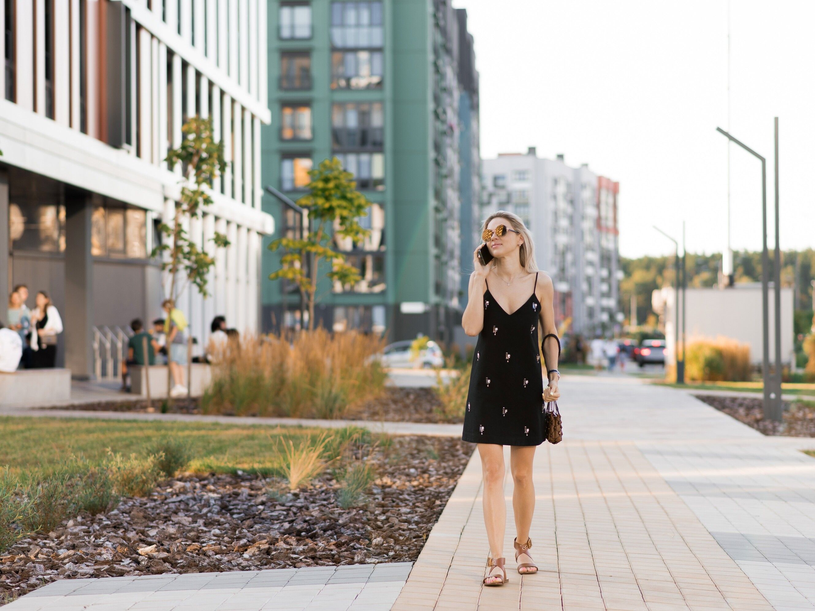 young-woman-walking-city-streets-with-while-talking-her-phone (1).jpg